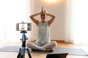 Yoga teacher, 40+ gives online yoga classes. Online video yoga class using a smartphone. Yoga teacher, 40+ gives online yoga classes. Online video yoga class using a smartphone.